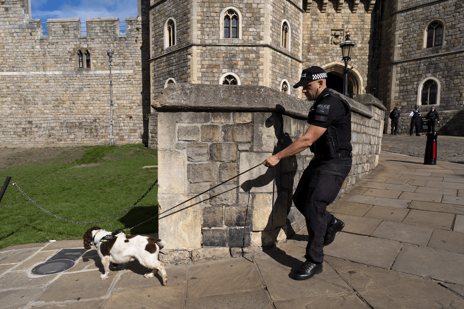 Security personnel conducting a sniffer dog check outside Windsor Castle during state visit preparations